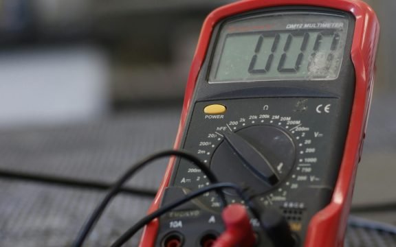 Professional multimeter with wires that combining functions of voltmeter ammeter ohmmeter placed on floor